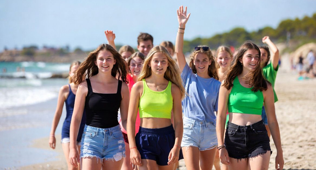 Young Adults am Strand in Mallorca während einer LISA! Sprachreise spazieren gemeinsam am Meer entlang und geniessen die Freizeit